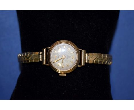 A vintage 18ct gold cased Tudor ladies manual winding wristwatch, on replacement expanding bracelet and another 9ct gold exam