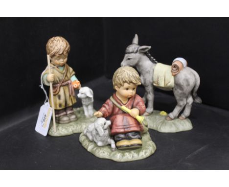 Three Hummel Nativity figures, shepherd standing, shepherd sitting and donkey