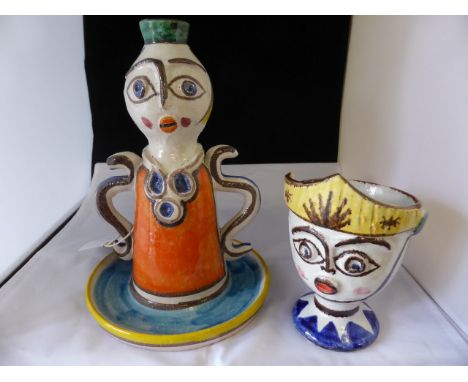 A mid 20th century Giovanni Desimone pottery candlestick, in the form of a comical figure, together with a comical face cup b