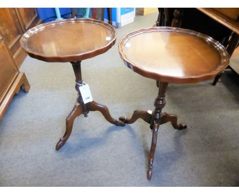 A pair of mahogany pie crust wine tables on tripod feet.