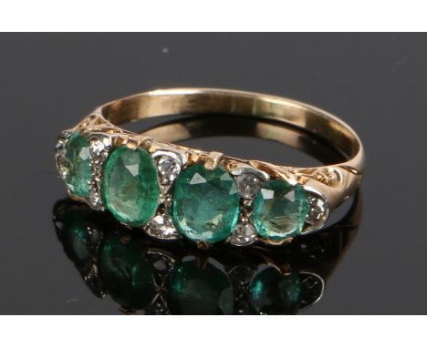 Emerald and diamond set ring, with four emeralds and eight diamond divides, estimated total emerald weight 1.29 carat, ring s