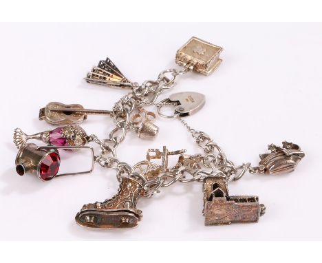 Silver charm bracelet set with eleven silver and plated charms, to include spinning wheel, ships lamp, ice skate etc. 61g