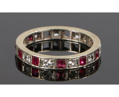Simulated ruby and clear paste set eternity ring, with square cut simulated rubies and round cut paste diamonds, some stones 