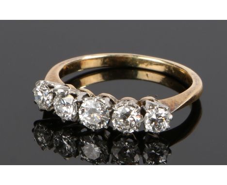 18 carat gold diamond set ring, with a row of five diamonds at an estimated total diamond weight of 1.1 carat, ring size J