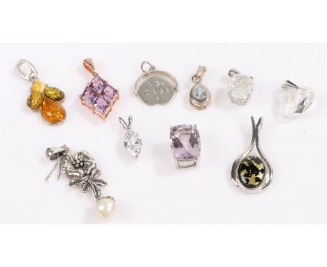 Ten silver pendants, to include an amber set example, 19.6g (10)Floral pearl effect pendant with piece of old necklace wrappe