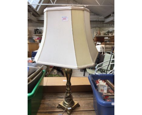 A brass lamp with shade 