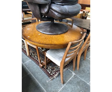 An oak round extending dining table with 4 teak ladder back chairs 