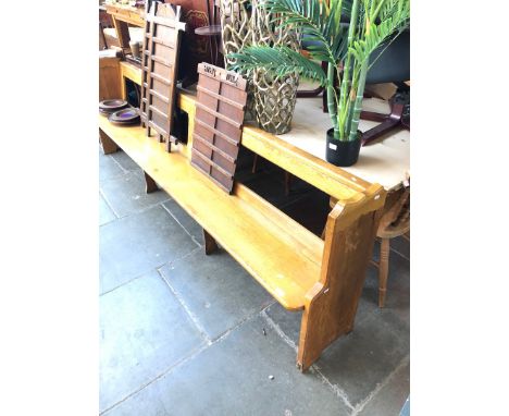 A large light oak pew 