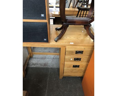 A modern light oak desk with 3 drawers 