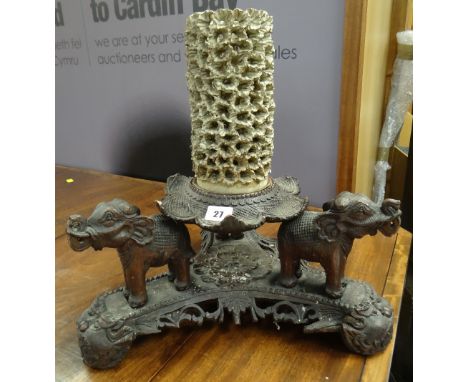 Carved Eastern design tri-form stand decorated with elephants &amp; dragons below a lotus leaf having ceramic cylindrical vas