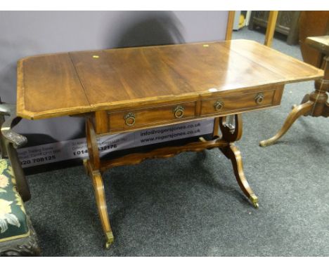 A good antique reproduction crossbanded mahogany drop-flap sofa-table with two drawers on lyre-form supports, 134cms extendin