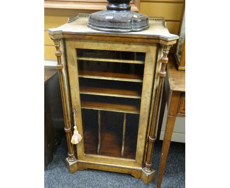 An antique walnut &amp; ebonized single-door music cabinet with inlaid decoration, the architectural columns with gilt metal 