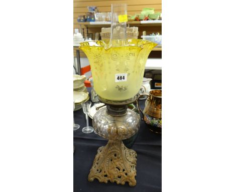 An antique cast metal oil lamp with glass reservoir &amp; tinted shade Condition Report: please request*  *Condition is not s