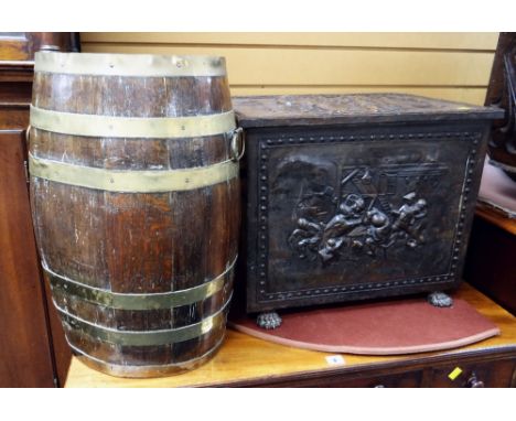 A good relief decorated metal coal box with twin handles &amp; claw feet together with an oval barrel form stick stand Condit