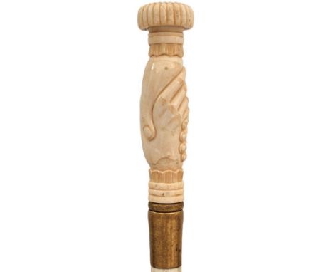 AN EARLY 20TH CENTURY MARINE IVORY TIPPLER'S WALKING CANE, the handle carved as clasped hands with the finial unscrewing to r