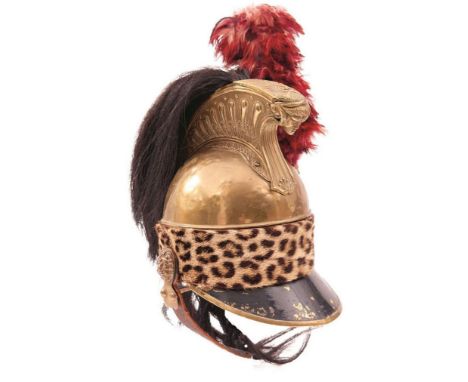 A 19TH CENTURY FRENCH CAVALRY HELMET, the brass skull with horse hair brush, red feather hackle and fur band, black painted p