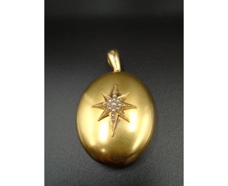18ct gold Victorian hallmarked oval locket with seed pearl North Star design on front and monogram to reverse, London 1877, l