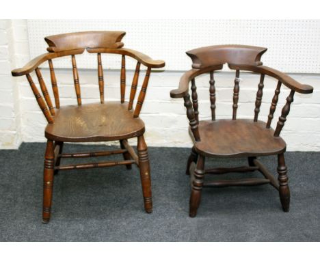 A 19th century beech and elm captain's chair, with bow rail, ring turned stick splats, solid seat, on splayed legs, together 