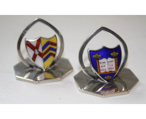 A pair of Edwardian menu holders, octagonal bases with shield shaped enamel plaques being coat of arms and mottos of Oxford U