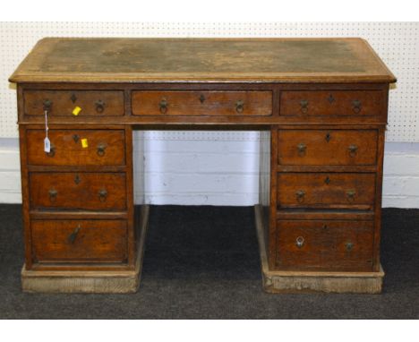 A late Victorian oak twin pedestal writing desk with leather inset top, 123cm