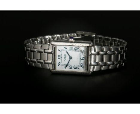 Must de Cartier, a gentleman's silver tank wristwatch, the rectangular enamel dial with Roman numerals and blued steel hands,