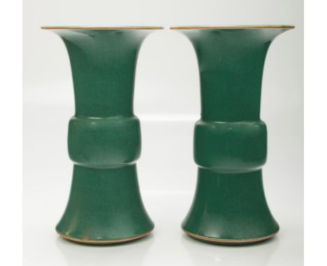 A pair of 19th century Chinese jade green glazed porcelain Gu shaped vases, with floral rims, 34.5cm high