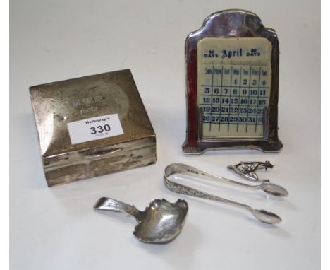 A silver cigarette box, 3 x 9 x 8cm, together with a silver desk calendar with ivorine leaves, a caddy spoon, pair of sugar n