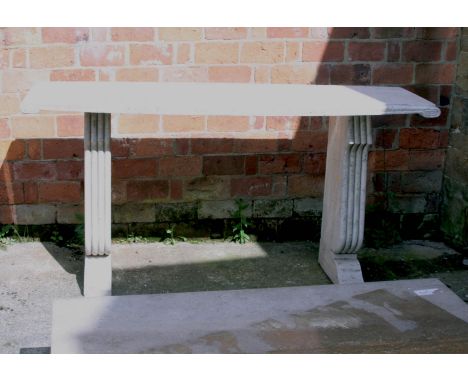 An Italian mottled cream travertine console table, the rectangular top with scroll ends on twin silhouette reeded supports an