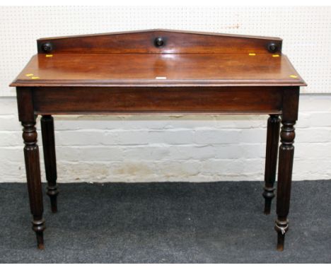 A William IV mahogany side table, the architectural upstand over rectangular top with moulded edge on reeded turned tapering 