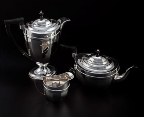 A four piece tea set, panelled oval form, the tea pot and hot water jug with ebonised wooden handles and wooden finials to do