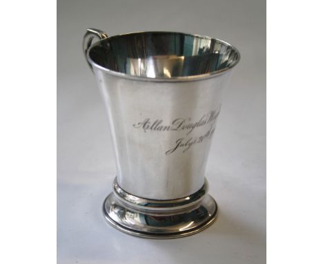 Henry Wilkinson, a silver christening mug, of cylindrical tapering form, with angular scrolled handle on stepped circular foo