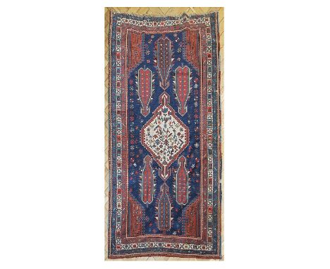 An early 20th century Caucasian Shakli rug, with distinctive arrow design, with multiple borders, 108 x 175cm