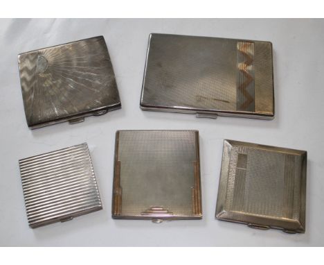 An Art Deco silver compact with gold inlay, an Art Deco engine turned cigarette case with reeded gold plated decoration, Birm