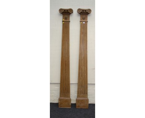 A pair of 19th century stripped pine architectural pilasters, of Doric form with scrolling capitals, 212cm high