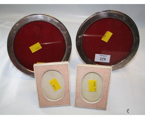 A pair of Edwardian silver photograph frames, plain circular with easel backs, Chester 1907, 15cm diameter, together with a p