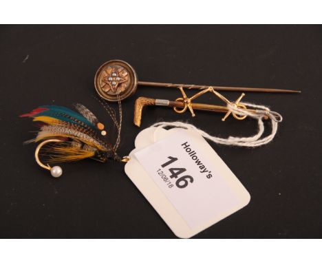 A stock pin in the form of a riding crop, with applied bits, a gold and cultured pearl fishing fly brooch and a Victorian sti