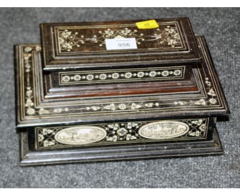 An early 20th century ebony and vizagapatam stepped desk stand, of sarcophagus form, decorated with trailing flowers and rese