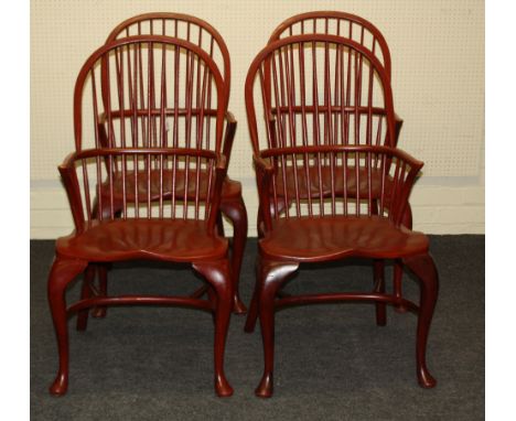 A set of four red painted beech double hoop and stick back Windsor armchairs, each with shaped seat on cabriole forelegs and 