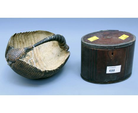 A George III oval mahogany and satin wood tea caddy with hinged cover, 14cm wide, together with an armadillo basket