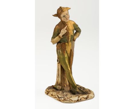 An early 20th century Royal Worcester No 2213 shot silk figure of a jester, with hand held high with finger extended marked f