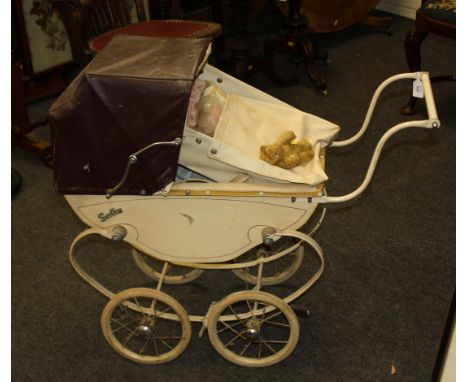 A vintage 'Swallow' pressed steel coach built pram, together with vintage hard plastic dolls, teddy bears and a carry cot