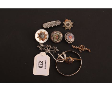 Four various military brooches and badges, one yellow metal and enamel, three bar brooches and a white metal christening brac