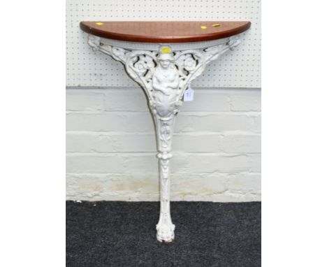 A Victorian cast iron console table, pierced decorated with Britannia and shield, terminating in a paw foot, with demi-lune m