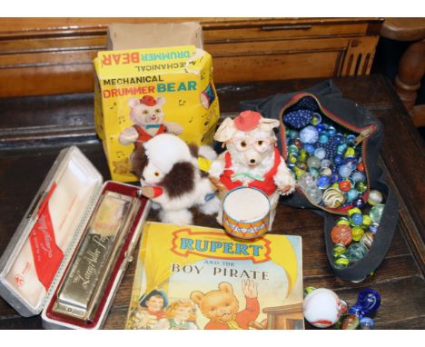 A 'Larry Adler' boxed harmonica, together with a collection of vintage glass marbles, Japanese tin-plate drumming bear, jumpi