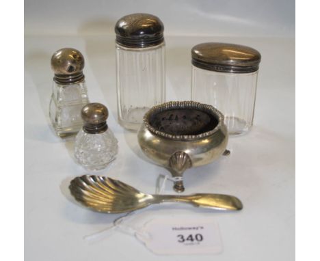 A silver plated caddy spoon with scallop bowl, a silver cauldron form salt and four silver capped dressing table jars, variou