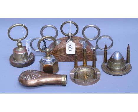 Two bullet mounted Trench Art ashtrays together with a shell mounted desk stand, various mounted heavy horse tethering rings,