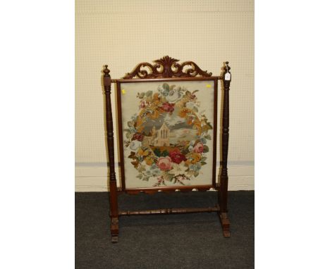 A late Victorian mahogany firescreen having a scrolling acanthus surmount above a glazed gros point and beadwork panel of an 