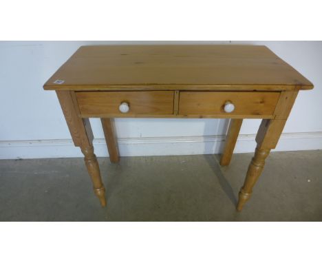 A Victorian style pine side table with two drawers, 84cm wide, 74cm high 