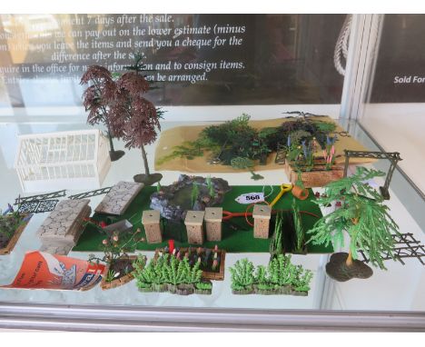 A collection of Britains miniature Floral Gardens, including trees, flower beds , a green house, motor mower, garden roller e