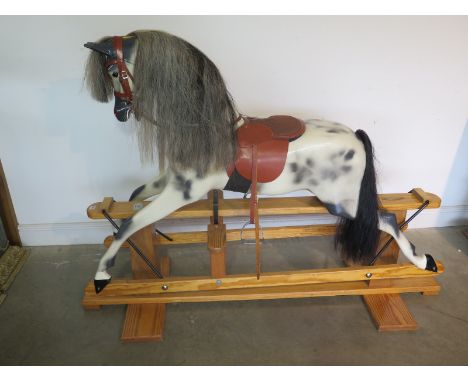 A Haddon rocking horse, dapple grey raised upon a pine base, approx 179.5cm long, 128cm high, in good condition 